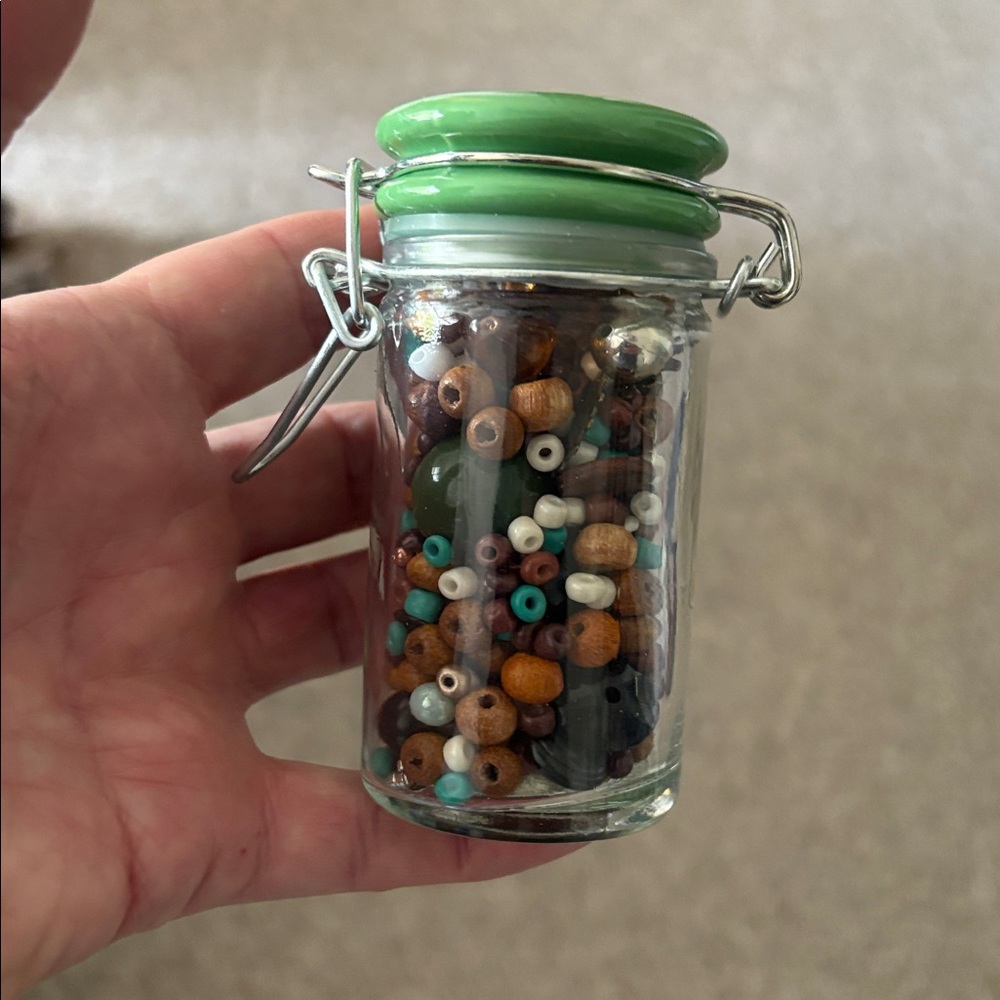 Green Glass Jar canister with Assorted Beads